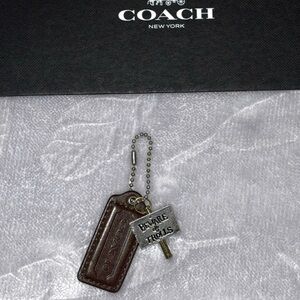 Bag Decor: Coach Chocolate Brown 2.25” Hang Tag with ‘Beware Of Trolls’ Charm